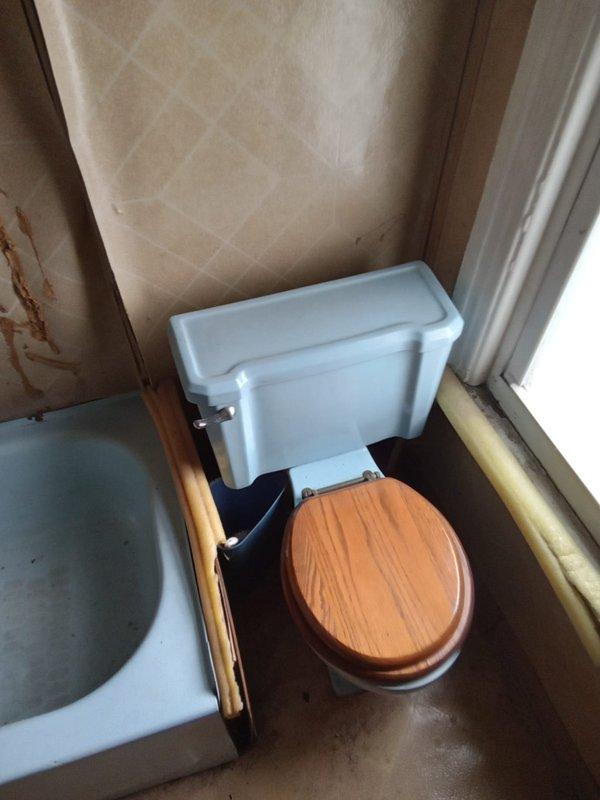 Conducted comprehensive plumbing assessment of residential property built in 1910 to provide repiping estimate. Evaluated existing bathroom fixtures including vintage toilet with ceramic tank, fiberglass bathtub, and aging supply lines showing signs of deterioration. Inspected kitchen cabinet plumbing system featuring white PVC drain assembly with P-trap configuration and metal supply lines. Documented condition of all visible plumbing infrastructure, noting wear patterns, potential corrosion on support structures, and water staining in cabinet areas. Provided detailed estimate for complete bathroom renovation and whole-house repiping project to address aging galvanized or original piping systems typical of early 20th century construction.