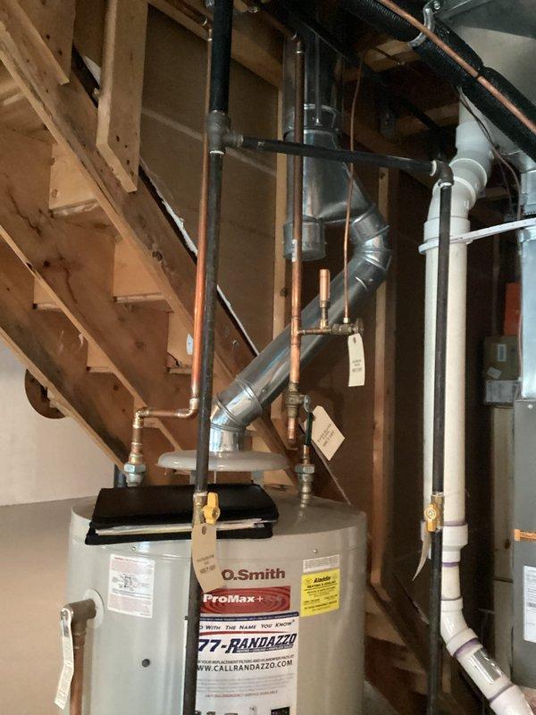 Conducted plumbing estimate for residential water heater system in unfinished basement utility area. Assessed existing A.O. Smith ProMax+ standard tank water heater installation with copper supply piping, PVC venting, and associated connections. Evaluated unit specifications, venting configuration, and mechanical room layout to provide replacement or service recommendations.