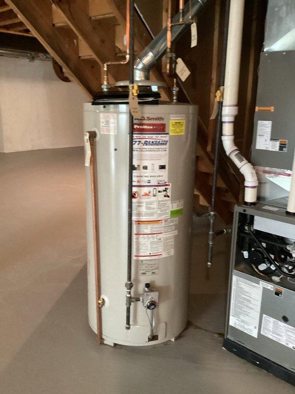 Conducted plumbing estimate for residential water heater system in unfinished basement utility area. Assessed existing A.O. Smith ProMax+ standard tank water heater installation with copper supply piping, PVC venting, and associated connections. Evaluated unit specifications, venting configuration, and mechanical room layout to provide replacement or service recommendations.