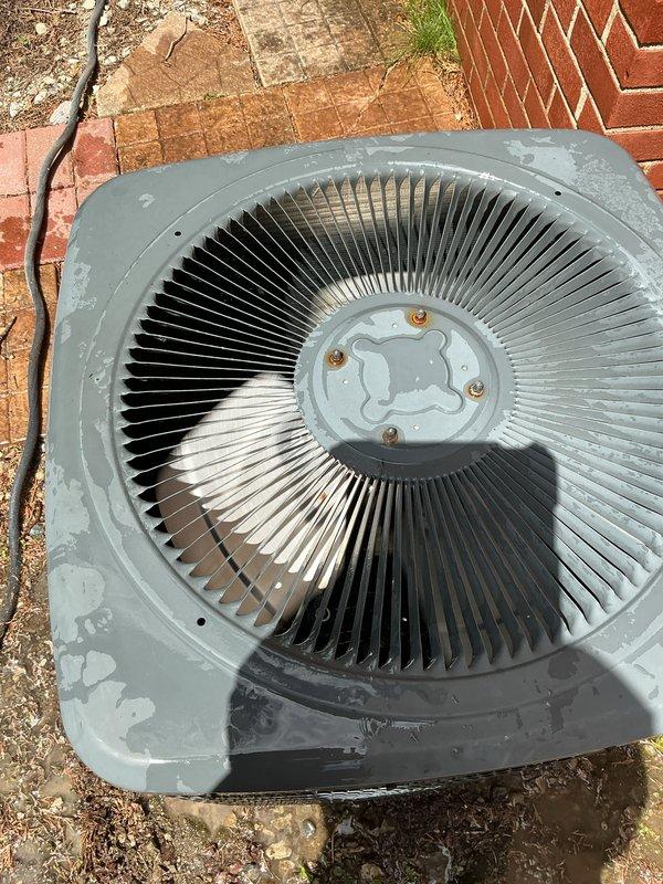 Completed comprehensive Gold-level air conditioning inspection on a 10-12 year old single-zone residential cooling system with air handler located in basement. Performed thorough examination of outdoor condenser unit, including visual assessment of fan assembly, housing integrity, and overall component condition. Documented system operation and captured detailed photographs showing condenser fan configuration with radial aluminum fins, central motor assembly, and unit placement on concrete pad. Noted weathering consistent with outdoor exposure and identified visible crack in exterior panel casing. Verified unit operational status and completed full inspection protocol as requested by homeowner.