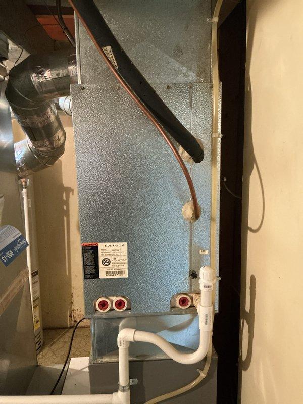 Conducted comprehensive assessment of existing HVAC system for replacement estimate. Evaluated 20-year-old air conditioning equipment located in basement and exterior areas. Documented current air handler installation featuring condensate management system with pump, PVC drainage lines, and refrigerant piping connections. Inspected ductwork configuration, electrical connections, and mechanical room layout to determine replacement requirements and system specifications for customer consideration.