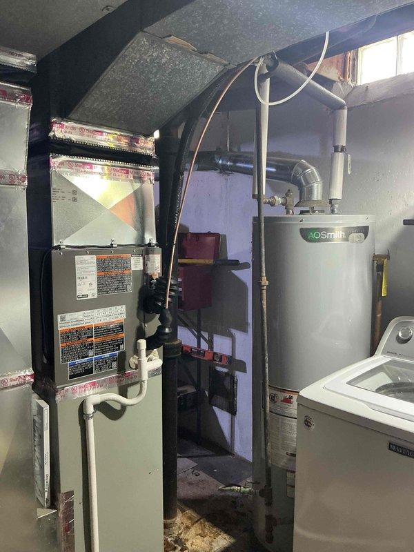 Completed installation of 2-ton air conditioning system with evaporator coil in basement utility area. System installed in rear location with reconnection to existing furnace unit. Mechanical, electrical, and AC permits obtained prior to installation. Electrical work coordinated with licensed electrician as required for proper system connection and code compliance. All refrigerant lines properly connected, insulated, and tested for leaks. System startup performed and unit operating within manufacturer specifications.