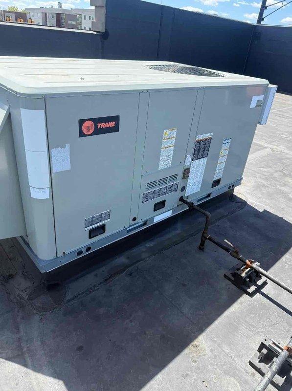 Completed scheduled commercial HVAC maintenance agreement service on two Trane packaged rooftop units. Performed comprehensive preventive maintenance inspections on both systems, including operational testing with diagnostic gauges to verify refrigerant pressures and system performance, visual inspection of electrical components and controls, examination of unit mounting and vibration dampening pads, and documentation of equipment condition through photographic records for maintenance history files.