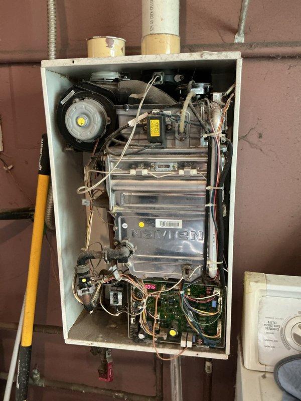 Responded to no hot water condition at residential property with Navien 240NG tankless water heater displaying error code. Upon arrival, unit was non-operational in laundry room location. Performed diagnostic assessment of internal components including heat exchanger, blower motor assembly, and control board circuits. Identified disconnected or loose electrical connections preventing proper unit operation. Reconnected wiring harness to circuit board and verified all electrical connections were secure throughout the system. Tested blower motor function and confirmed heat exchanger integrity. Cycled unit through complete startup sequence, cleared error codes from control panel, and restored hot water service to all fixtures throughout the home. Unit returned to normal operating parameters with proper ignition, flame detection, and temperature modulation confirmed.