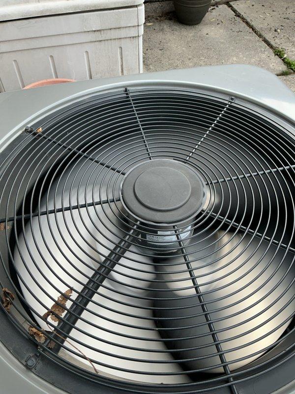 Completed comprehensive tune-up on 4-year-old HVAC system with basement-located evaporator coil. Performed thorough inspection of outdoor condenser unit (Model XC140360E300D, 36,000 BTU, manufactured January 2021), verified proper fan operation and protective grille integrity, checked electrical connections and voltage specifications at 208/230V. Inspected indoor components including humidifier functionality, thermostat calibration and operation, and hot water tank condition. All system components found operating within normal parameters with no deficiencies noted; unit maintained in good working condition with clean exterior surfaces and adequate airflow through condenser assembly.