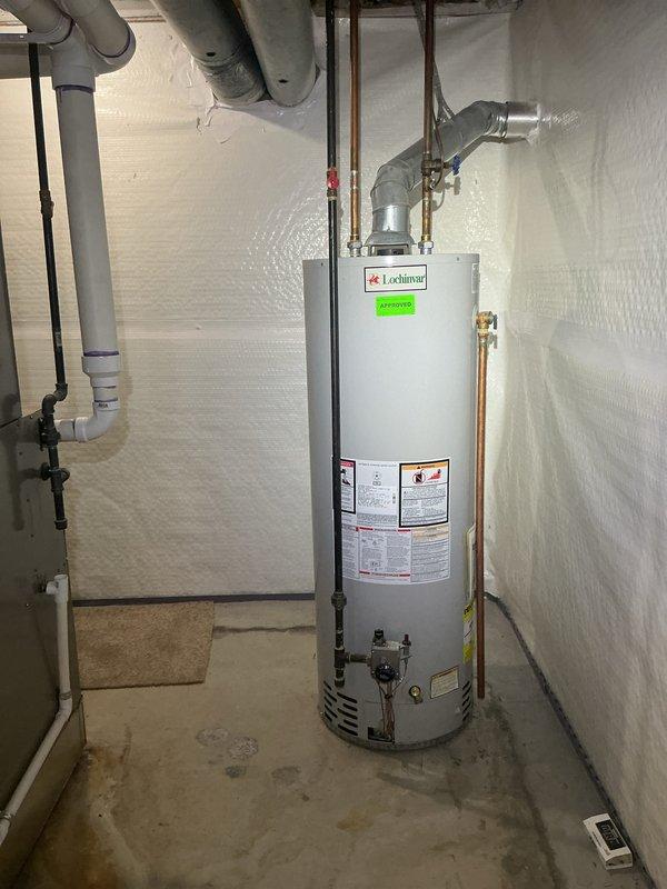 Completed comprehensive Gold AC inspection on residential single-unit system installed in 2018 with air handler located in basement. Performed full system evaluation including thermostat operation verification, temperature differential measurements, and visual inspection of all accessible components. System found operating within normal parameters with Emerson digital thermostat displaying proper temperature readings and responsive controls. Documented equipment condition through photographic records showing properly functioning thermostat and basement mechanical room layout. All safety checks passed and unit confirmed operational at time of service.