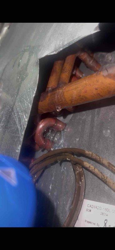 Responded to follow-up service call for 11-year-old air conditioning system with evaporator coil located in basement. Previous technician had identified refrigerant loss requiring leak detection and repair. Utilized LD 5000 Prowler electronic leak detector to perform comprehensive leak search on refrigeration circuit. Located active refrigerant leak at copper tubing connection point near evaporator coil assembly. Copper lines showed significant oxidation and age-related deterioration consistent with system age. Repaired leak at defective fitting connection, pressure tested system to verify repair integrity, evacuated system to remove moisture and non-condensables, and recharged unit to manufacturer specifications. Verified proper system operation and refrigerant charge upon completion.
