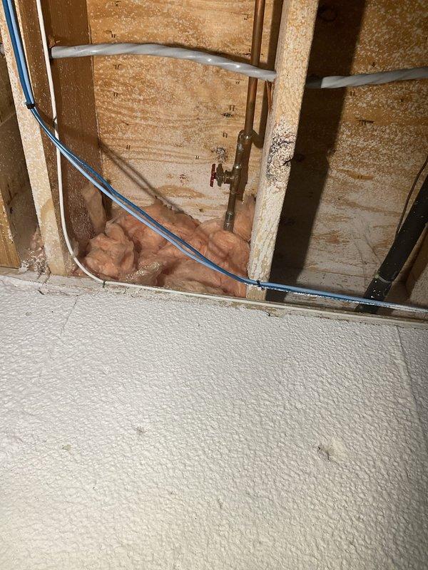Responded to a leaking gate valve in the basement of a 25-year-old home. Upon arrival, assessed the failed gate valve which had been actively leaking for several days. Presented multiple valve replacement options to the homeowner for selection. Removed the deteriorated gate valve and installed a new quarter-turn ball valve for improved ease of operation and reliability. Opened interior wall cavity to access the water supply line, exposing framing and insulation as needed for proper valve replacement. Tested the new valve installation for proper operation and verified no leaks were present. Restored wall access point and cleaned work area. System returned to full operational status with improved shutoff functionality.