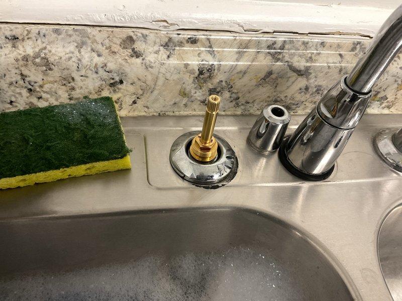 Responded to commercial plumbing repair for kitchen faucet valve replacement. Upon arrival, identified failed valve cartridge in stainless steel kitchen sink faucet assembly. Disassembled faucet components, removed defective valve stem, and documented existing plumbing configuration including under-sink drainage system with P-trap and garbage disposal unit. Ordered Speakman RPG05-0534-CA replacement cartridge for installation. Placed bucket under sink to catch any residual drainage during service. Work area secured and customer notified of parts procurement timeline for completion of repair.