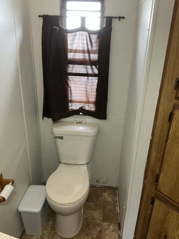 Conducted on-site evaluation of existing gas water heater to assess code compliance and provide estimate for potential conversion to electric unit. Inspected current installation located in interior closet space, noting deteriorated surrounding conditions and aging infrastructure. Evaluated existing gas supply line configuration, venting system, and available electrical capacity to determine feasibility of converting from gas to electric water heater. Assessed clearance requirements, accessibility, and structural considerations for new electric unit installation. Documented current water heater specifications and installation conditions through photographic evidence. Provided homeowner with professional assessment regarding code compliance issues and outlined scope of work required for electric conversion, including new dedicated electrical circuit installation, removal of existing gas lines, and proper venting modifications.