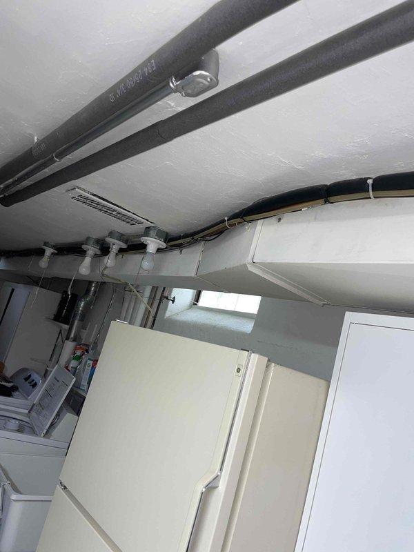 Completed HVAC estimate for replacement of 20-year-old air conditioning system located in basement utility area. Assessed existing equipment condition, documented installation space constraints and surrounding mechanical infrastructure including piping and electrical conduits, and provided comprehensive replacement options to address aging system requiring upgrade.