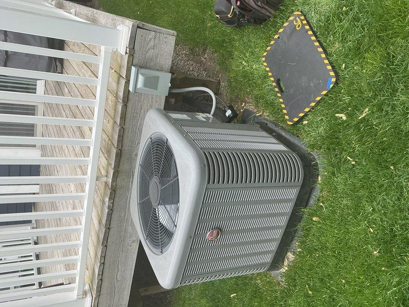 Completed comprehensive air conditioning tune-up and maintenance on 10-year-old system under gold plan coverage. Serviced outdoor condenser unit positioned on concrete pad adjacent to residence and inspected indoor furnace/air handler unit located in basement mechanical room. Performed standard preventive maintenance procedures including cleaning condenser coils, checking refrigerant levels, inspecting electrical connections, testing capacitor and contactor operation, verifying proper airflow, and ensuring all safety controls functioning correctly. Examined copper refrigerant lines, flexible gas connections, and PVC condensate drainage system for proper operation and secure fittings. System operating within manufacturer specifications with no deficiencies noted at time of service.