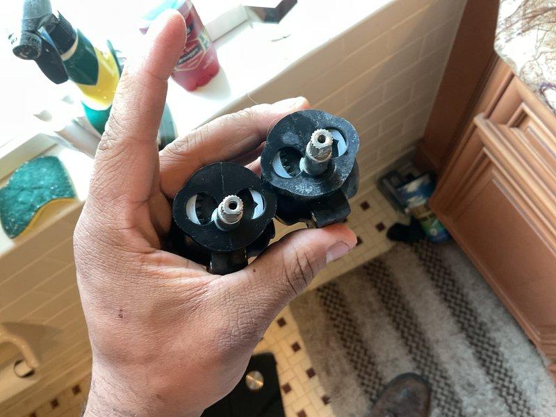 Replaced defective Tempress II pressure balance cartridge and stem adapter in shower valve assembly. Removed old worn components and installed new Sigma faucet parts including escutcheon hub assembly to restore proper temperature control and water flow. Shower valve now operates correctly with balanced hot and cold water pressure.