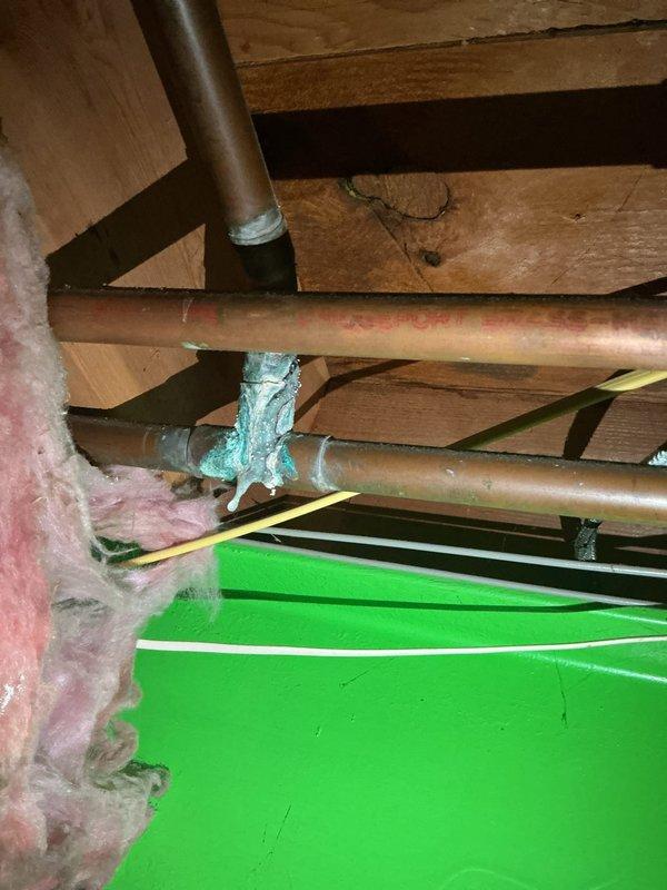 Completed comprehensive Gold AC inspection on 5-year-old residential air conditioning system with air handler and coil located in basement. System was operational upon arrival with homeowner present. Performed full visual inspection of indoor air handling equipment, including examination of copper refrigerant lines, condensate drainage system, and electrical connections. Inspected evaporator coil assembly and surrounding ductwork infrastructure within basement mechanical space. Verified proper insulation coverage on refrigerant lines and noted existing repair material on copper piping joints. Evaluated structural mounting and support of air handler components. Documented equipment condition through photographic records showing basement installation area, exposed ceiling joists, copper line sets, and insulation materials. All system components found operating within normal parameters at time of inspection.