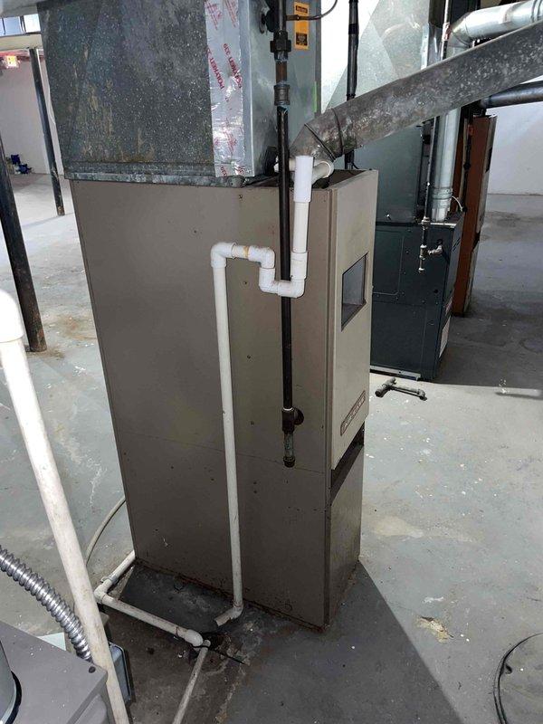 Conducted on-site assessment of non-operational furnace system in basement mechanical room, unit age 20+ years. Evaluated existing beige air handler with associated ductwork, PVC condensate drainage system, and metal supply/return duct configuration. Provided comprehensive replacement estimate for new furnace system to restore heating functionality to the property.