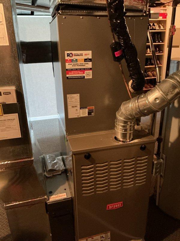 Completed comprehensive Gold AC inspection on 1-year-old Bryant HVAC system with air handler located in basement. Verified proper thermostat operation on White-Rodgers programmable unit displaying appropriate temperature readings and functional control settings. Inspected furnace unit, ductwork connections, and associated components with all equipment confirmed operational and in good working condition. System passed inspection with no deficiencies noted.