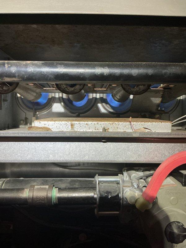 Completed comprehensive tune-up and inspection on 18-year-old Lennox XP14-036-230-01 air conditioning unit and gas furnace system. Inspected outdoor condenser unit containing HFC-410A refrigerant, verified manufacturer specifications and electrical ratings at 208/230V, and documented unit condition. Performed internal inspection of gas furnace assembly, examined burner operation with protective seals, checked gas valve assembly with connections, and assessed heat exchanger components for proper function and safety compliance.