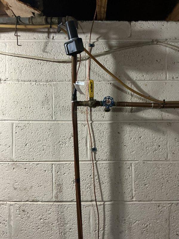 Responded to customer inquiry regarding backflow prevention testing and sprinkler system options. Upon inspection of the basement plumbing infrastructure, evaluated the existing copper piping system and backflow prevention assembly with blue-handled valve. Assessed the sprinkler system connection points and discussed options with homeowner for either annual backflow testing certification or permanent cap-off of the irrigation system to eliminate future testing requirements.