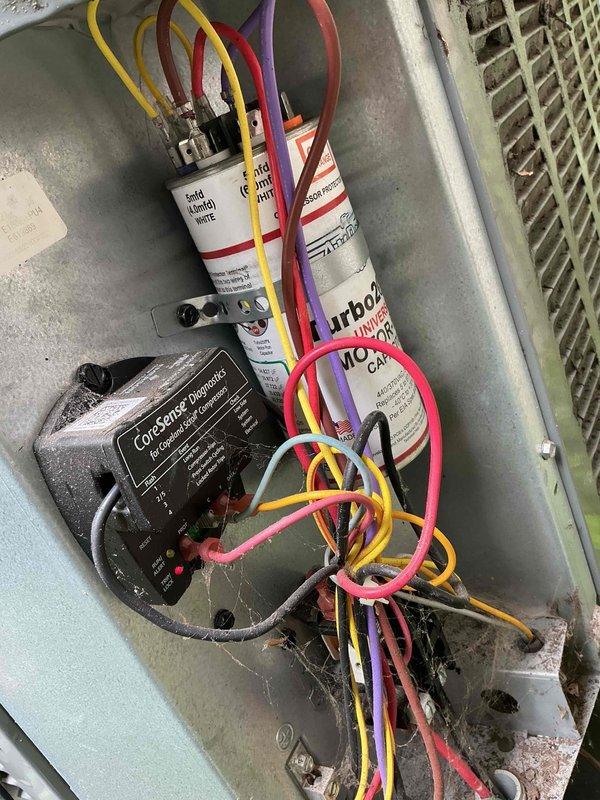 Responded to service call for central air conditioning system not cooling at full strength. Upon inspection, accessed electrical control panel and evaluated capacitors, wiring connections, and CoreSense diagnostic module for proper operation. Examined outdoor condenser unit positioned in landscaped area, checking for airflow obstructions, refrigerant levels, and overall system performance to diagnose reduced cooling capacity and restore unit to optimal operating condition.