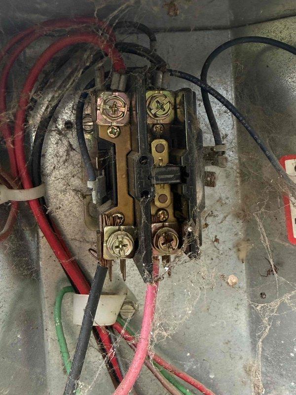 Responded to emergency no-cool call for air conditioning system over twenty years old. Upon arrival, found outdoor condenser unit with significant age-related wear, dirt accumulation, and weathered components. Inspected electrical connections at terminal block, which showed oxidation and environmental exposure consistent with the system's age. Photographed equipment condition and electrical connections for documentation. Unit failed to operate due to age-related component failure, requiring system replacement recommendation given the advanced age of the equipment exceeding its expected service life.