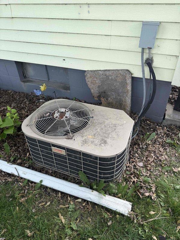 Responded to emergency no-cool call for air conditioning system over twenty years old. Upon arrival, found outdoor condenser unit with significant age-related wear, dirt accumulation, and weathered components. Inspected electrical connections at terminal block, which showed oxidation and environmental exposure consistent with the system's age. Photographed equipment condition and electrical connections for documentation. Unit failed to operate due to age-related component failure, requiring system replacement recommendation given the advanced age of the equipment exceeding its expected service life.