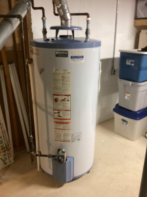 Performed comprehensive AC tune-up on lower level air conditioning system utilizing digital refrigeration monitoring equipment. Connected Testo diagnostic instruments to measure system performance parameters including suction pressure (107.2 psi at 34.9°F), discharge pressure (273.5 psi at 89.6°F), suction line temperature (47.5°F), and liquid line temperature (76.7°F). System operating on R410A refrigerant showed superheat reading of 12.6°F against target superheat of 5.3°F, indicating slightly elevated superheat conditions. Subcooling measured at 12.9°F, within acceptable range. Documented ambient conditions with air temperature at 78.3°F, relative humidity at 58.7%, dew point at 62.6°F, and wet bulb temperature at 67.7°F. Captured photographic documentation of equipment location in utility area alongside water heating equipment for service records.