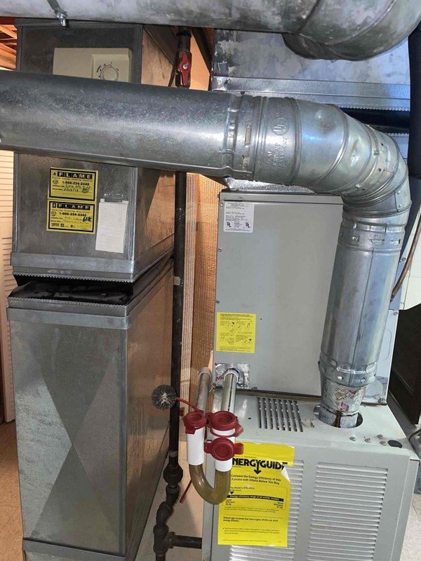 Completed comprehensive estimate for full HVAC system replacement on 25-year-old equipment experiencing electrical issues, specifically lights dimming when compressor engages indicating high starting amperage draw. Inspected basement-located air handler, furnace unit, existing ductwork infrastructure, and refrigerant line routing. Documented current system configuration including dual equipment setup with galvanized metal ductwork, copper refrigerant lines, and wall penetrations to provide accurate replacement specifications and equipment sizing recommendations.