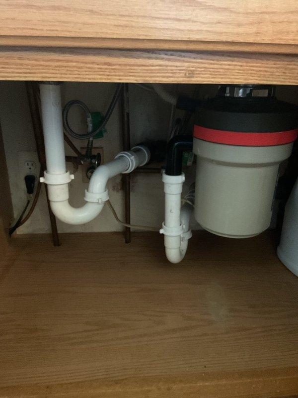 Responded to service call for garbage disposal making gurgling noise. Upon inspection of under-sink plumbing and drainage system, identified improper venting causing air pressure issues in the drain line. Verified P-trap configuration and checked vertical stack connections in basement to ensure proper drainage flow. Cleared any partial blockages in the drain line and confirmed all connections were secure and functioning properly. Tested disposal operation post-service to verify gurgling noise was eliminated and drainage was flowing smoothly without air pressure disruptions.