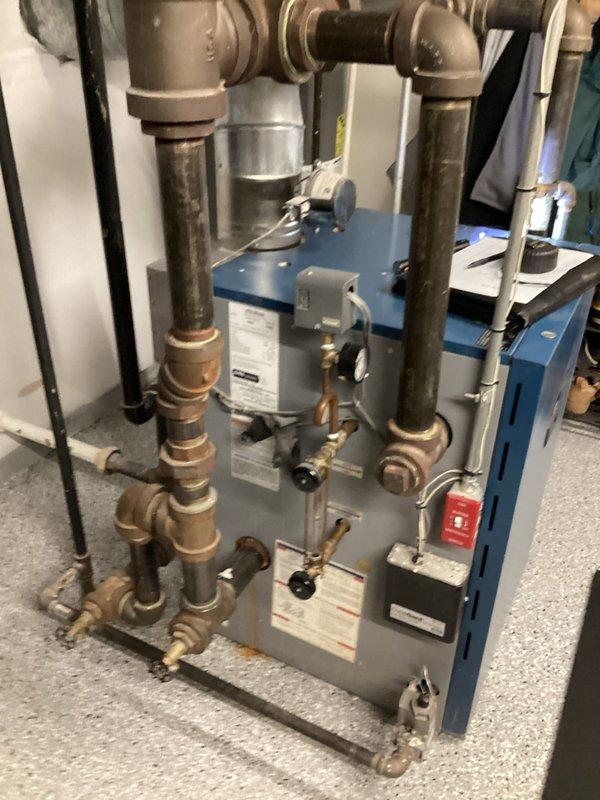 Responded to a steam boiler leak in the basement for a 10+ year old unit. Upon inspection, identified significant sediment buildup throughout the system due to lack of regular flushing maintenance, and discovered a corroded 2" nipple on the wet return line that was the source of the active leak. Documented system conditions with photographs and provided estimate for necessary repairs including replacement of the corroded nipple and complete system flush to remove accumulated sediment and restore proper operation.