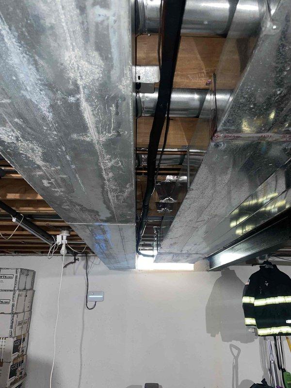 Conducted comprehensive site assessment for complete HVAC system replacement. Evaluated existing ductwork installation in basement mechanical room, documenting current system configuration including horizontal trunk lines, rigid metal transitions, and mounting hardware conditions. Photographed exposed ceiling joists, existing duct strapping, electrical panel locations, and available workspace for new equipment installation. Assessed structural support requirements and clearance specifications needed for proposed heating and cooling equipment. Provided detailed measurements and photographic documentation to prepare accurate full system replacement estimate.