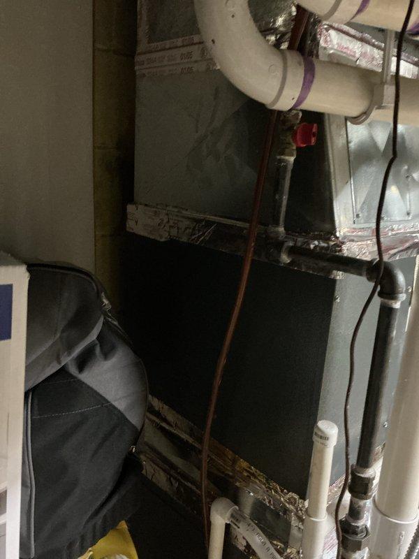 Provided comprehensive estimate for HVAC system replacement at residential property with 18-year-old equipment. One air conditioning unit currently non-operational while second unit remains functional. Assessment revealed significant frost and ice buildup on evaporator coil assembly located in basement, indicating potential refrigerant leak, restricted airflow, or system failure. Existing natural gas furnace with coil assembly, PVC condensate drainage system, copper refrigerant lines, and metallic ductwork evaluated for replacement options. Documented current installation configuration including air handler, evaporator coil with extensive frost accumulation, and associated mechanical components for equipment sizing and replacement specifications.