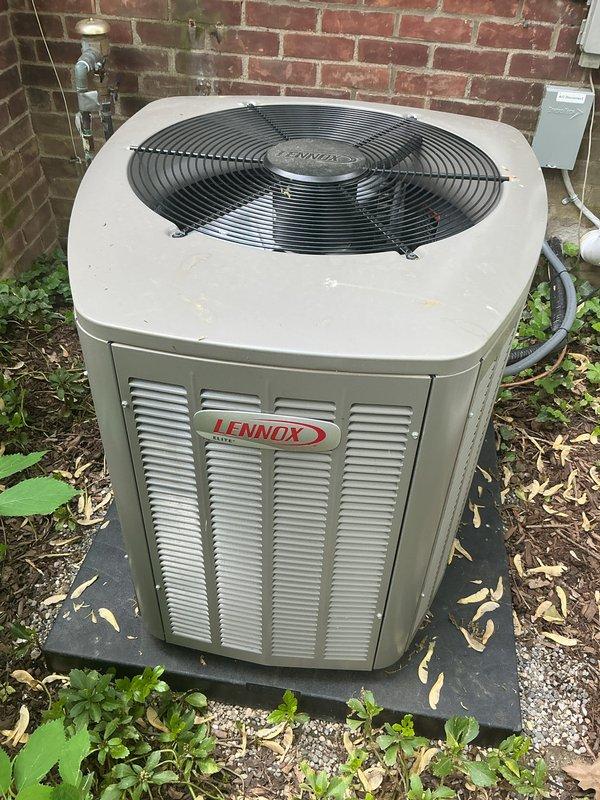 Completed comprehensive Gold AC inspection on 10+ year old Lennox condensing unit with air handler located in basement. Unit is operational and functioning properly. Observed debris accumulation including leaves, mulch, and vegetation growth around condenser base and pad area. Advised customer that area surrounding condenser requires clearing of debris and organic material to maintain proper airflow and system efficiency. Inspected condenser fan assembly, refrigerant lines, electrical disconnect, and exterior cabinet condition. All components examined and found to be in acceptable working order with normal age-related wear present.