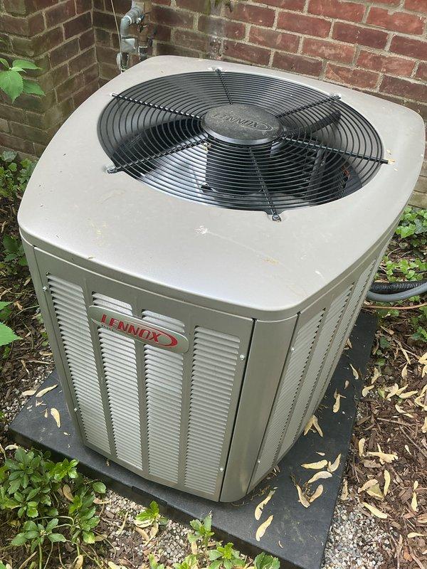 Completed comprehensive Gold AC inspection on 10+ year old Lennox condensing unit with air handler located in basement. Unit is operational and functioning properly. Observed debris accumulation including leaves, mulch, and vegetation growth around condenser base and pad area. Advised customer that area surrounding condenser requires clearing of debris and organic material to maintain proper airflow and system efficiency. Inspected condenser fan assembly, refrigerant lines, electrical disconnect, and exterior cabinet condition. All components examined and found to be in acceptable working order with normal age-related wear present.