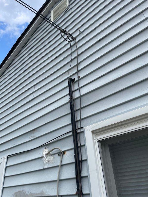 Provided estimate for complete HVAC system replacement at residential property with failed equipment. Existing R22 air conditioning unit was empty of refrigerant and inoperable, with furnace of similar age also requiring replacement. Indoor temperature exceeded 90 degrees at time of assessment, creating urgent comfort and safety concerns for occupants. Documented existing exterior equipment location, electrical service routing, refrigerant line sets, and conduit configurations mounted on vinyl siding. Assessed installation requirements including utility connections, condensate drainage, and accessibility for replacement equipment.