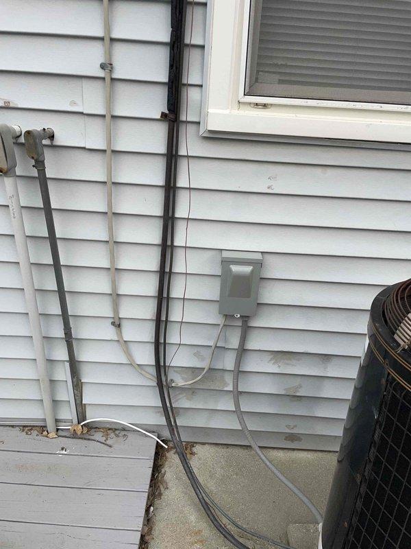 Provided estimate for complete HVAC system replacement at residential property with failed equipment. Existing R22 air conditioning unit was empty of refrigerant and inoperable, with furnace of similar age also requiring replacement. Indoor temperature exceeded 90 degrees at time of assessment, creating urgent comfort and safety concerns for occupants. Documented existing exterior equipment location, electrical service routing, refrigerant line sets, and conduit configurations mounted on vinyl siding. Assessed installation requirements including utility connections, condensate drainage, and accessibility for replacement equipment.