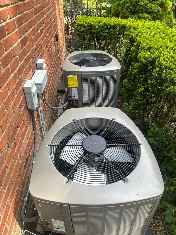 Completed air conditioning system startup for dual outdoor condenser units located in basement zone. Performed comprehensive system commissioning including electrical verification at disconnect boxes, refrigerant charge confirmation, airflow testing, and operational checks on both units. Verified Evolution thermostat programming and confirmed proper communication between indoor and outdoor equipment, with system maintaining setpoint at 76°F in AUTO fan mode.