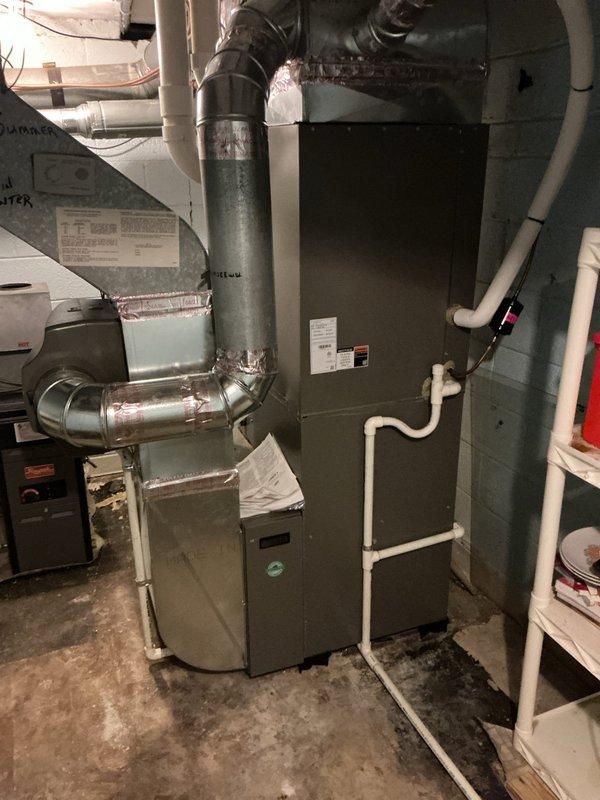 Completed comprehensive Gold AC inspection on 10-year-old residential HVAC system with air handler located in basement and condenser unit positioned outdoors against building exterior. Inspected furnace, ductwork connections, humidifier component, and verified proper operation of cooling system. Advised customer that area surrounding outdoor condenser unit requires clearing of debris, vegetation overgrowth including ivy encroachment, and any animal waste to ensure optimal airflow and system performance.