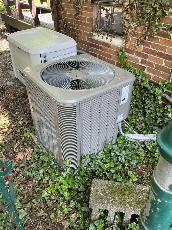 Completed comprehensive Gold AC inspection on 10-year-old residential HVAC system with air handler located in basement and condenser unit positioned outdoors against building exterior. Inspected furnace, ductwork connections, humidifier component, and verified proper operation of cooling system. Advised customer that area surrounding outdoor condenser unit requires clearing of debris, vegetation overgrowth including ivy encroachment, and any animal waste to ensure optimal airflow and system performance.