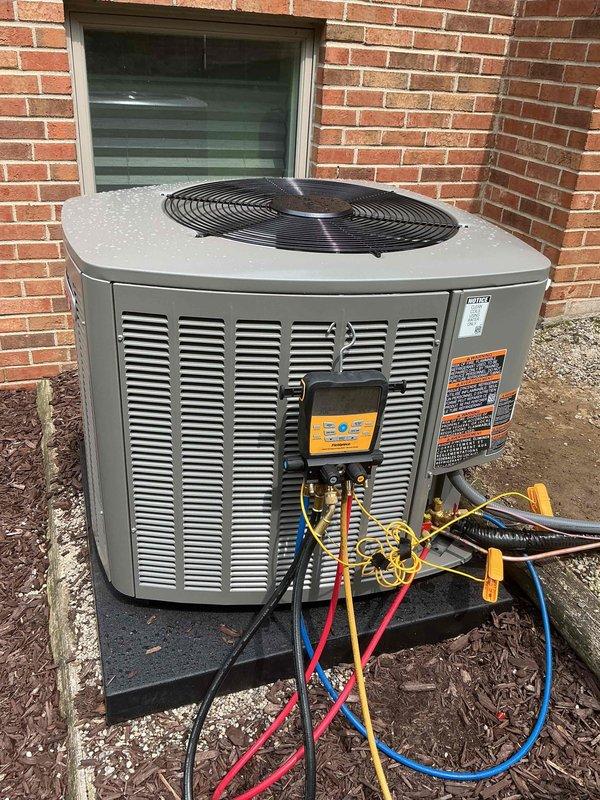 Completed installation of 4-ton air conditioning system with matching evaporator coil at rear of residence. Positioned new condensing unit on concrete pad, established refrigerant connections, performed system startup and diagnostics using manifold gauges to verify proper refrigerant charge and operating pressures. All components tested and operational, with mechanical permit requested for compliance documentation.