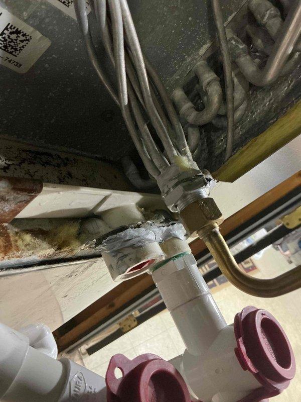 Completed comprehensive Gold AC Inspection on a 2-year-old single HVAC system with air handler located in basement. Performed thorough examination of refrigerant lines, service ports, electrical connections, and valve assemblies. All copper piping, compression fittings, and connection points inspected for proper operation and integrity. System confirmed operational with no deficiencies noted. Documented equipment condition with photographic records showing valve assembly, refrigerant line connections, and electrical wiring configurations.