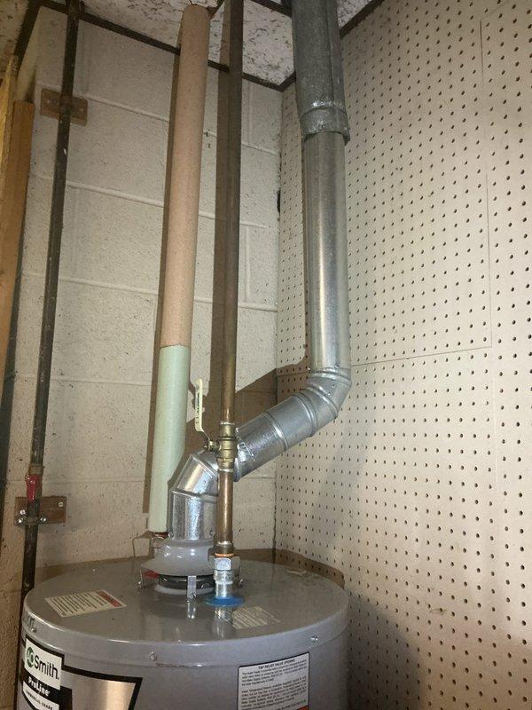 Responded to service call for failed residential water heater. Upon arrival, assessed existing tanked water heater unit located in basement mechanical room. Unit exhibited complete failure with no hot water production. Confirmed pilot light was extinguished and burner assembly was non-operational. 

Inspected existing venting system consisting of metallic ductwork with proper draft configuration and insulated sections. Verified all plumbing connections including supply and discharge lines were intact. Evaluated electrical connections and gas supply lines for proper function and safety compliance.

Performed diagnostic testing on thermocouple, gas valve, and ignition system. Determined water heater had reached end of serviceable life and required full replacement. Proceeded with complete water heater removal and installation of new unit. Reconnected all existing plumbing infrastructure, gas supply line, and venting system to manufacturer specifications. Tested pilot ignition, burner ope