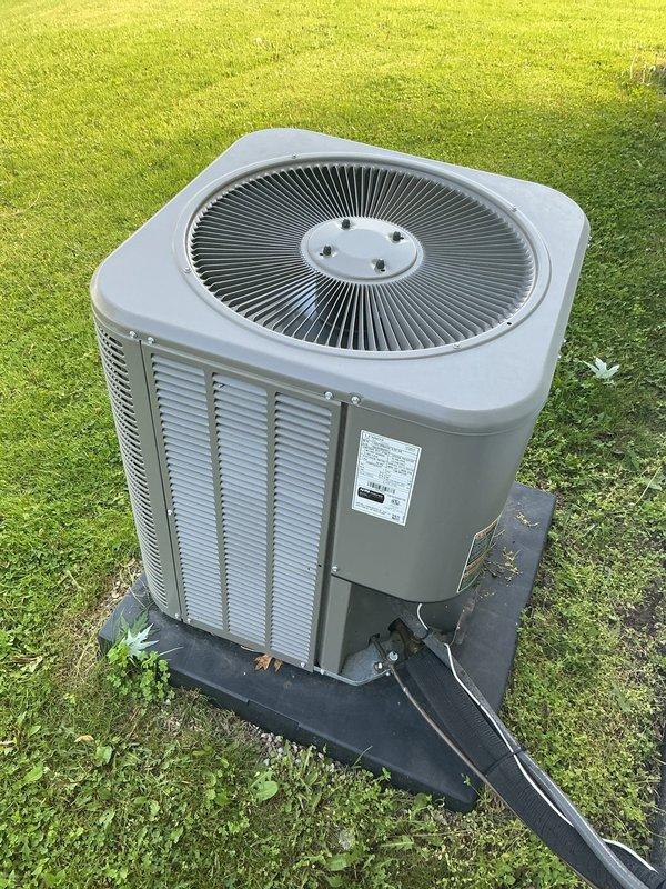 Completed annual Gold Plan maintenance inspection on 3-year-old residential air conditioning system with air handler located in attic and outdoor condenser unit. Performed comprehensive tune-up including visual inspection of both indoor and outdoor components, verified proper airflow through condenser louvers and fan operation, checked refrigerant lines and electrical conduit connections for integrity, and confirmed unit is operating within manufacturer specifications. Condenser unit found in excellent condition with no signs of damage, deterioration, or debris accumulation; pad placement and lawn clearance adequate for proper ventilation and drainage.