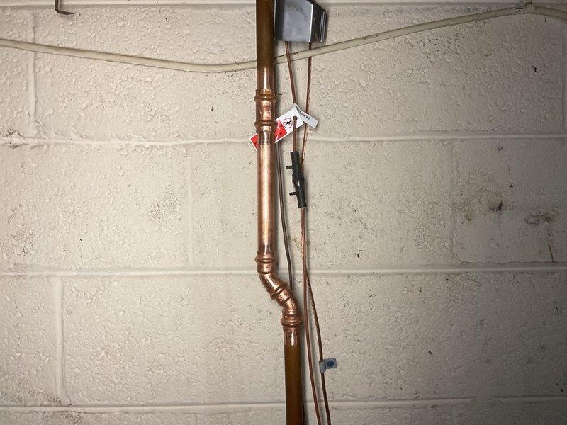 Removed existing PVB (Pressure Vacuum Breaker) assembly from copper water supply line system in basement utility area. Disconnected device from vertical copper piping, capped or reconfigured water lines as needed to maintain system integrity, and ensured proper water flow restoration to downstream fixtures. All connections were properly sealed and tested for leaks upon completion.