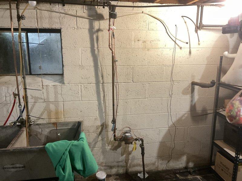 Removed existing PVB (Pressure Vacuum Breaker) assembly from copper water supply line system in basement utility area. Disconnected device from vertical copper piping, capped or reconfigured water lines as needed to maintain system integrity, and ensured proper water flow restoration to downstream fixtures. All connections were properly sealed and tested for leaks upon completion.