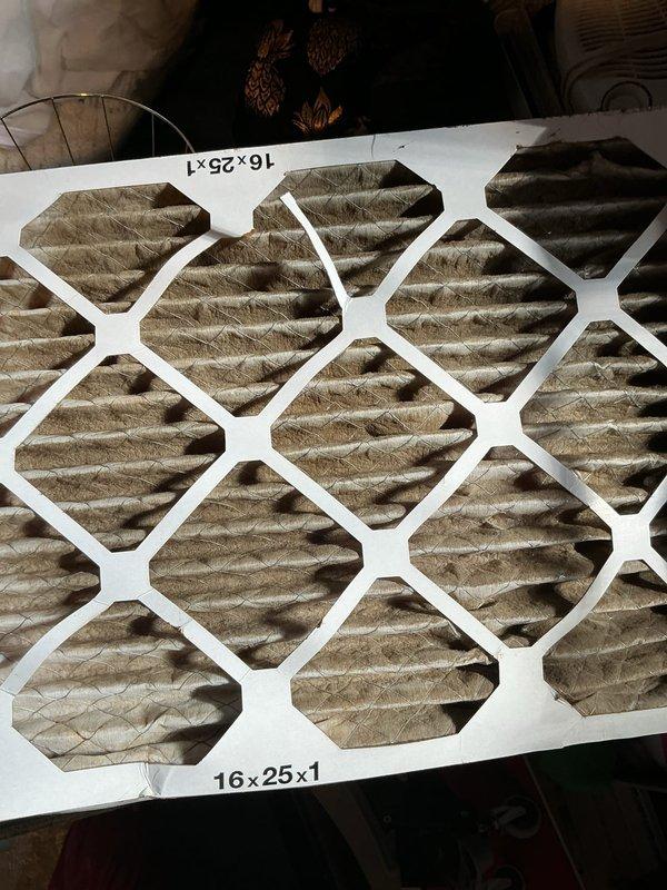 Responded to service call for central air conditioning system not adequately cooling the home, with Ecobee thermostat reporting a 4.8-degree temperature increase despite continuous cooling demand. Upon inspection, found severely clogged 16x25x1 air filter heavily loaded with dust and debris, significantly restricting airflow through the system. Replaced dirty air filter with new unit, inspected outdoor condenser unit for proper operation, and verified system returned to normal cooling capacity with adequate airflow restored throughout the home.