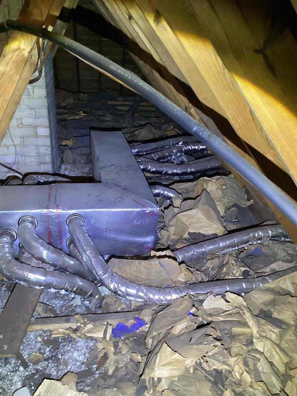 Provided comprehensive replacement estimate for 20+ year old attic-mounted air conditioning system with natural gas furnace. Inspected existing evaporator coil assembly showing significant dust accumulation and age-related wear, along with blue air handler unit and associated ductwork distribution system. Evaluated complete HVAC system configuration including serpentine coil design, insulated flex duct runs, and overall equipment placement within attic space to determine optimal replacement options for customer consideration.