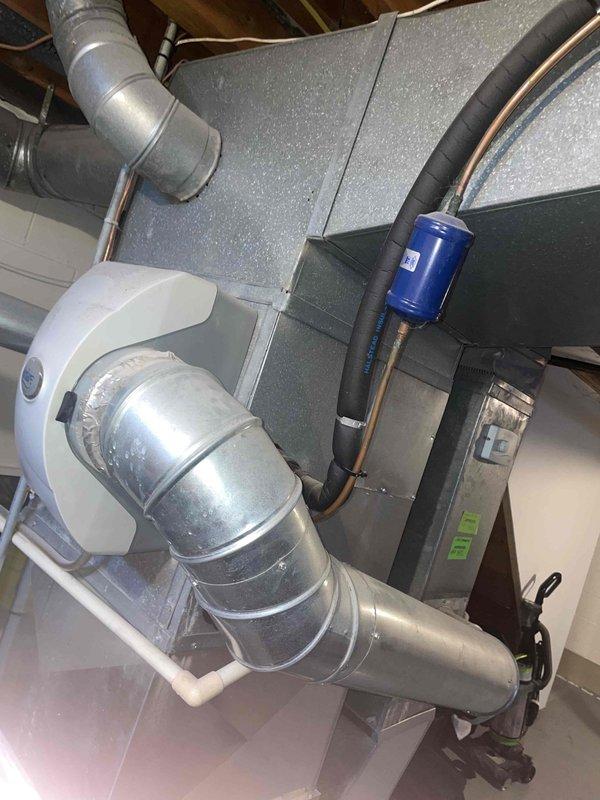 Conducted on-site evaluation for air conditioning system replacement estimate. Assessed existing 40-year-old outdoor AC unit located in backyard, inspected indoor air handler and ductwork system in basement utility area, and documented current HVAC configuration including metal ductwork connections, refrigerant lines, and electrical components to provide comprehensive replacement quote for aging system.