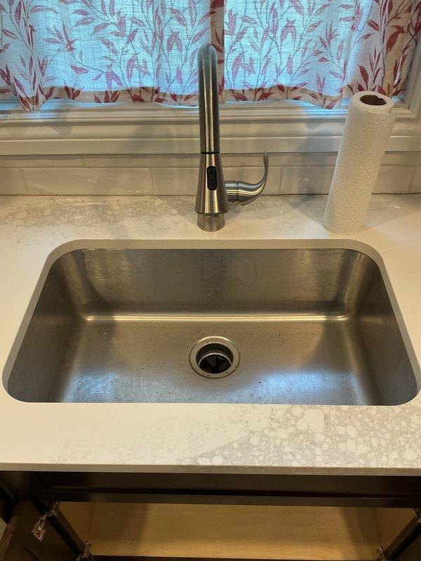 Responded to kitchen sink drainage issue where water was not draining and garbage disposal would not activate. Upon inspection, diagnosed inoperative garbage disposal unit and cleared drainage obstruction in the undermount sink system. Verified proper electrical connections to disposal unit, tested reset function, and ensured all PVC drain lines and trap assemblies were properly secured and functioning. Restored full drainage capability to kitchen sink and confirmed garbage disposal operational status upon completion.