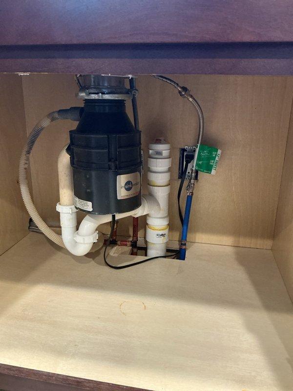 Responded to kitchen sink drainage issue where water was not draining and garbage disposal would not activate. Upon inspection, diagnosed inoperative garbage disposal unit and cleared drainage obstruction in the undermount sink system. Verified proper electrical connections to disposal unit, tested reset function, and ensured all PVC drain lines and trap assemblies were properly secured and functioning. Restored full drainage capability to kitchen sink and confirmed garbage disposal operational status upon completion.