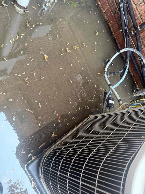 # HVAC Maintenance Report

Completed comprehensive Gold AC inspection on 2-year-old air conditioning system. Upon arrival, found outdoor condenser unit installed on rooftop with significant standing water accumulation and organic debris present on surrounding surface, indicating drainage concerns that could impact equipment longevity.

Performed detailed system evaluation including electrical component inspection. Removed and examined contactor assembly, which displayed moderate corrosion and wear on contact surfaces and terminal screws despite relatively new equipment age. Corrosion likely accelerated by exposure to standing water conditions observed on rooftop installation area.

Documented equipment condition through photographic records showing condenser unit positioning, rooftop water accumulation issues, and corroded electrical components requiring attention. System operational at time of inspection, though environmental conditions and component degradation warrant monitoring for